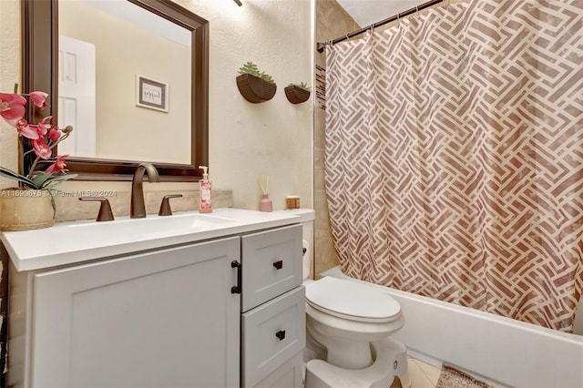 bathroom with tile patterned flooring, vanity, and toilet