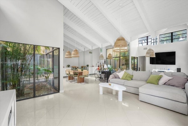 living room with tile patterned floors, beamed ceiling, and high vaulted ceiling