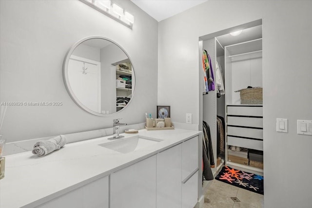 bathroom with vanity, tile patterned floors, and a spacious closet