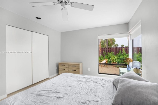 bedroom with a closet, wood finished floors, and a ceiling fan