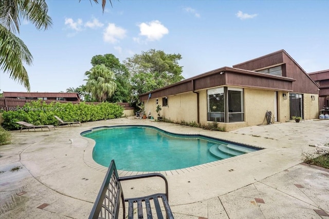 view of swimming pool featuring a patio and a fenced in pool