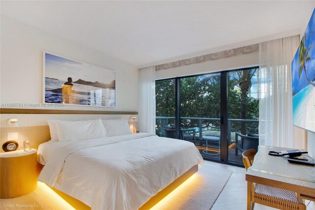 bedroom with access to outside and light hardwood / wood-style flooring