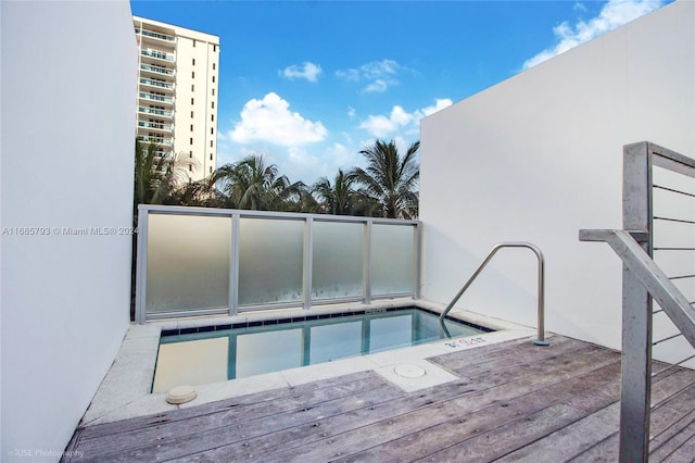 view of swimming pool with a deck