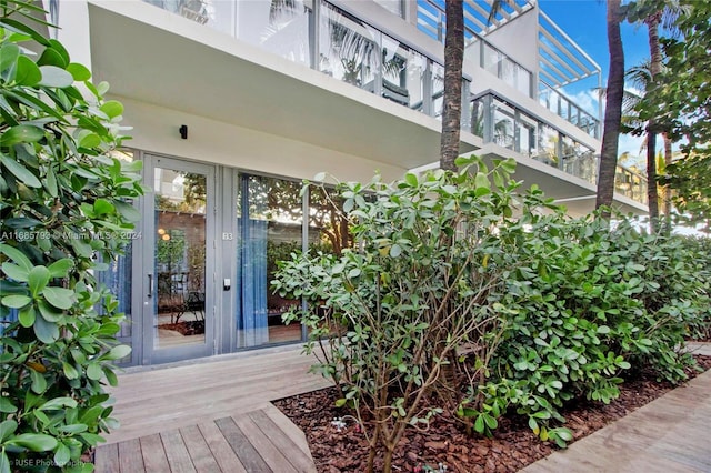 property entrance with a balcony and french doors