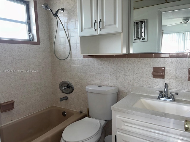 full bathroom with toilet, tile walls, tiled shower / bath, tasteful backsplash, and vanity