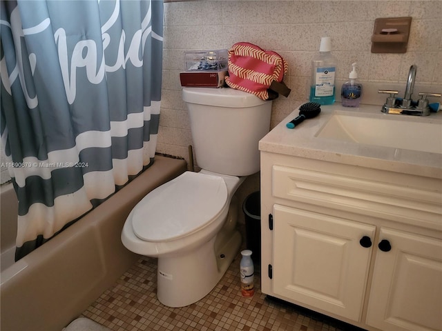 full bathroom featuring tile patterned floors, toilet, tile walls, vanity, and shower / bathtub combination with curtain