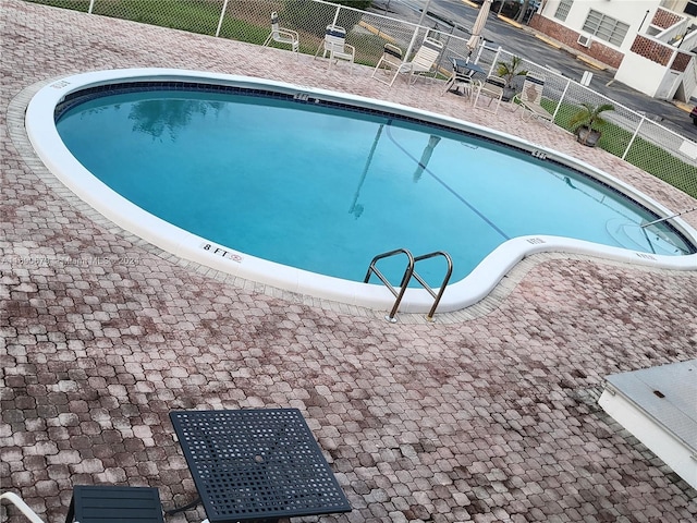 view of swimming pool featuring a patio area