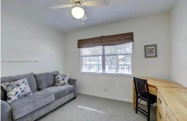 office area with ceiling fan and light carpet