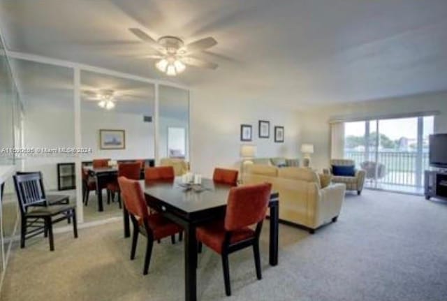 carpeted dining room featuring ceiling fan