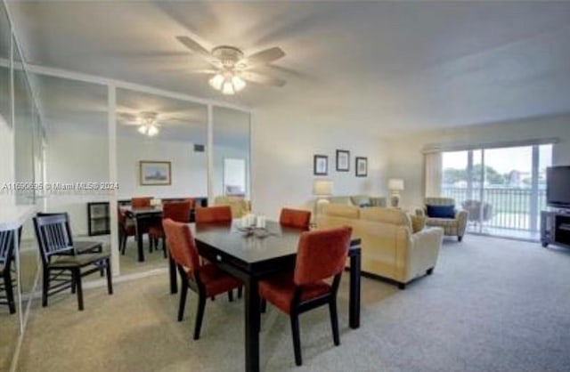 carpeted dining room featuring ceiling fan