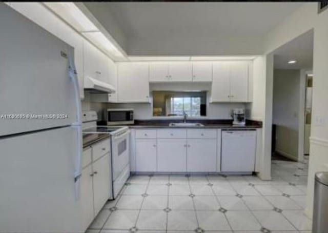 kitchen featuring white cabinetry, sink, and white appliances