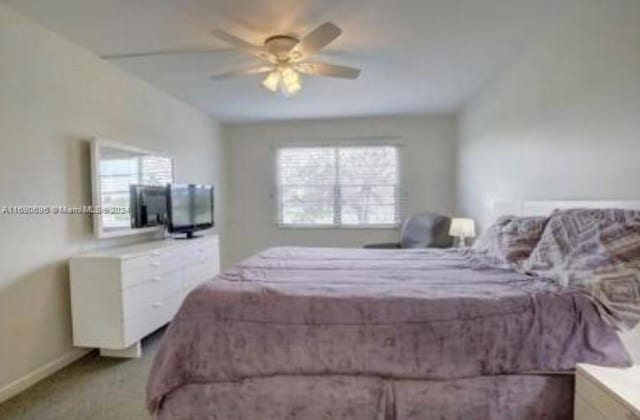 carpeted bedroom featuring multiple windows and ceiling fan