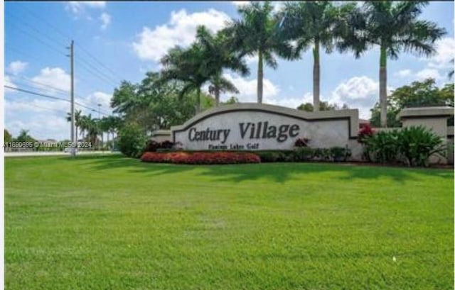 community sign featuring a lawn