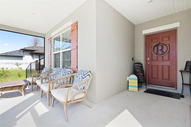 view of exterior entry with covered porch