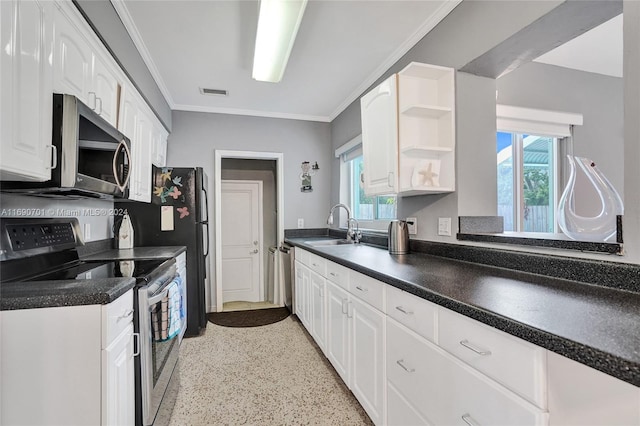 kitchen featuring white cabinets, appliances with stainless steel finishes, crown molding, and sink