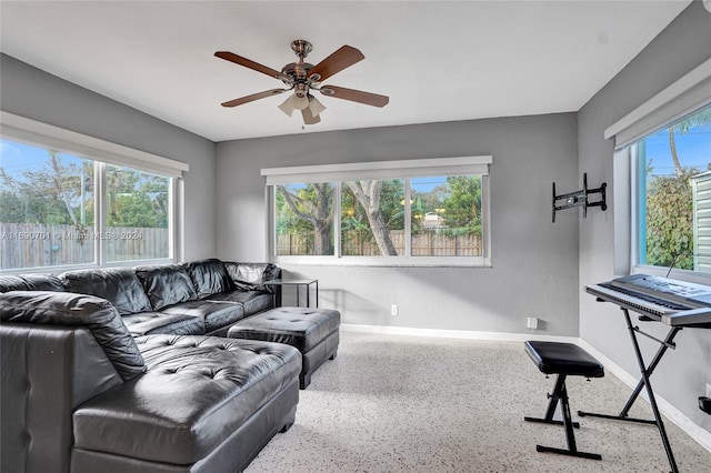 living room with ceiling fan and a healthy amount of sunlight