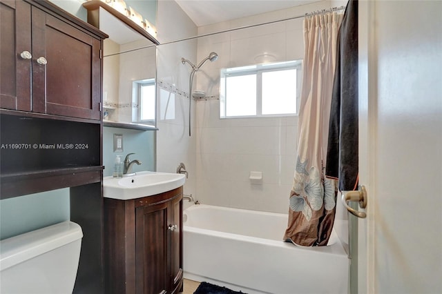 full bathroom with shower / bathtub combination with curtain, vanity, and toilet