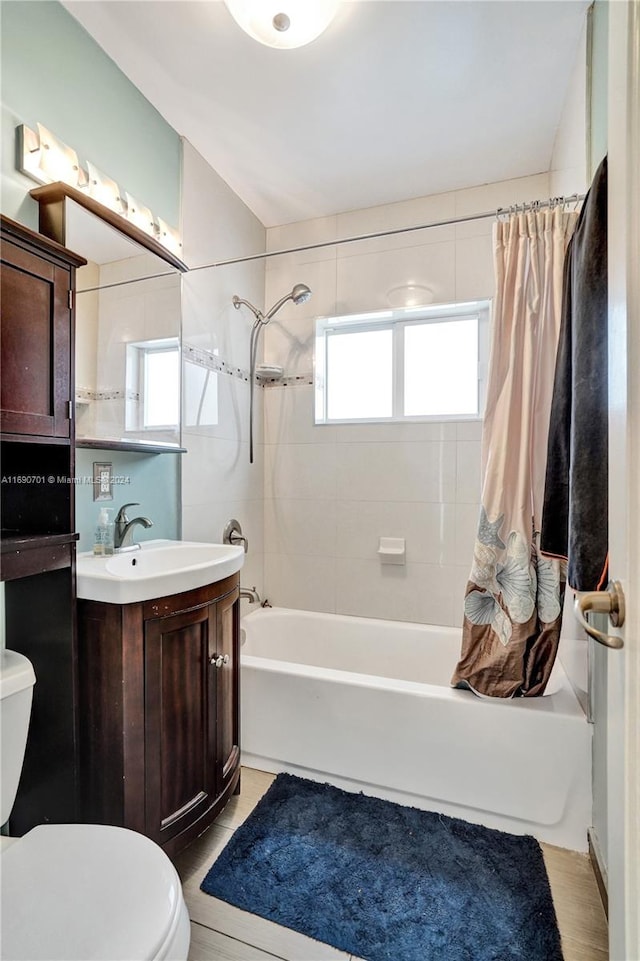 full bathroom with shower / bath combination with curtain, toilet, and vanity