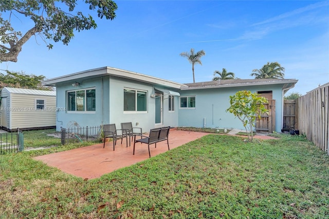 rear view of property featuring a yard and a patio