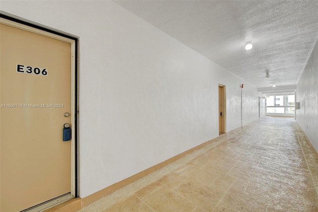 corridor featuring a textured ceiling