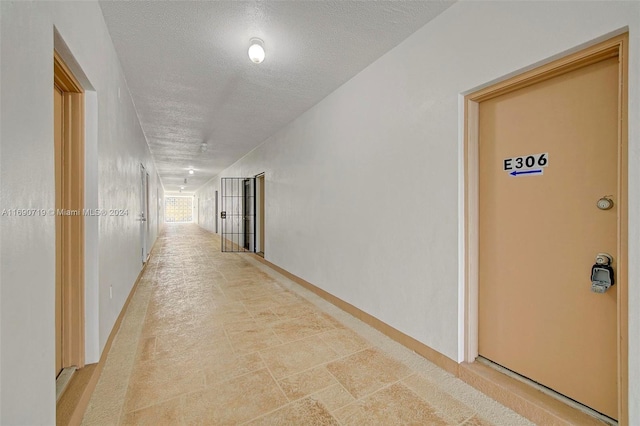 corridor featuring a textured ceiling