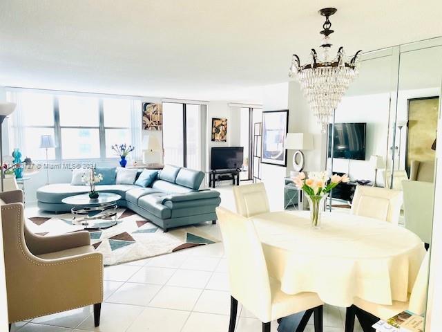 living room featuring light tile patterned floors and a chandelier