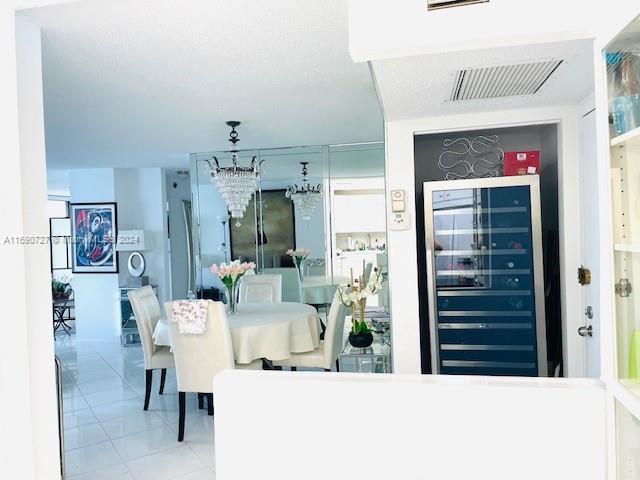 dining room featuring beverage cooler and bar area