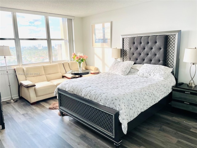 bedroom featuring a textured ceiling and dark wood-type flooring