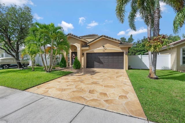 mediterranean / spanish-style house with a garage and a front lawn