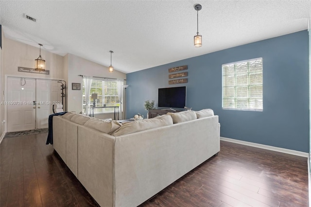 living room featuring dark wood-type flooring, a textured ceiling, and lofted ceiling