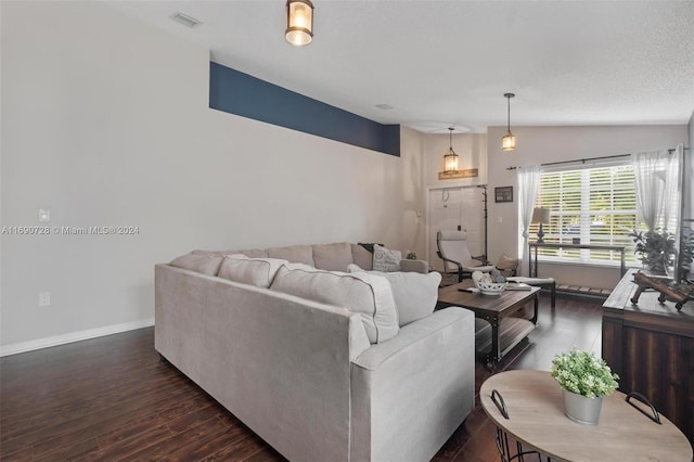 living room with dark wood-type flooring, a textured ceiling, and lofted ceiling