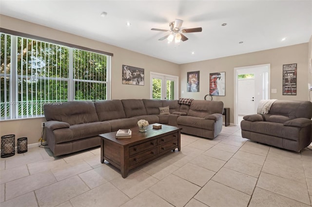 living room with ceiling fan and light tile patterned floors