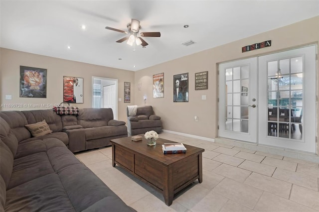 tiled living room featuring french doors and ceiling fan