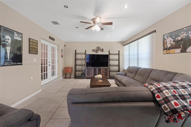 living room with light tile patterned flooring, ceiling fan, and french doors