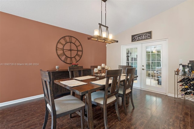 dining area featuring french doors, dark hardwood / wood-style flooring, lofted ceiling, and an inviting chandelier