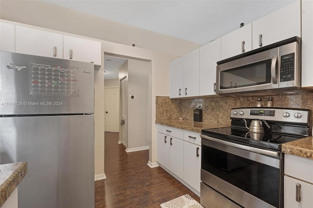 kitchen featuring white cabinetry, appliances with stainless steel finishes, and light stone counters