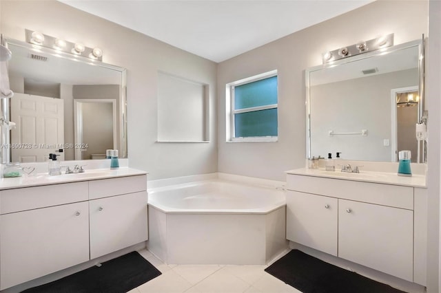 bathroom featuring tile patterned flooring, vanity, and a tub