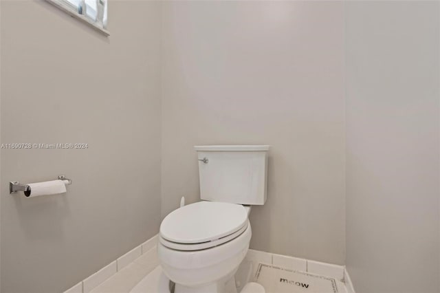 bathroom with tile patterned flooring and toilet