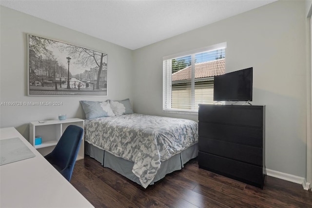 bedroom with dark hardwood / wood-style floors