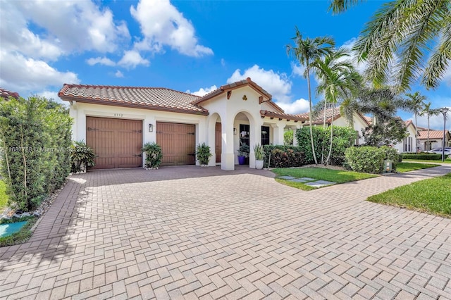 mediterranean / spanish-style house with a garage