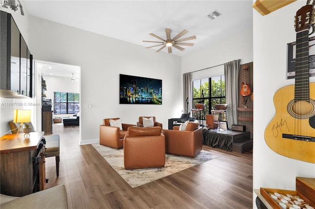 living room featuring light hardwood / wood-style floors and ceiling fan