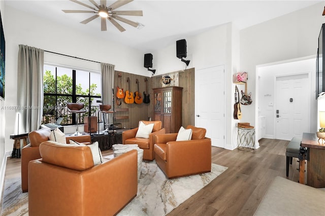 living room featuring hardwood / wood-style floors and ceiling fan