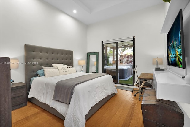 bedroom featuring access to exterior and wood-type flooring