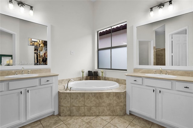 bathroom featuring vanity, tile patterned floors, and shower with separate bathtub