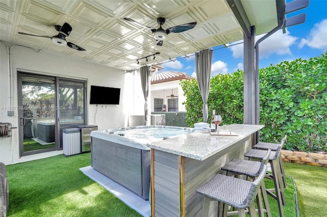 view of patio / terrace with an outdoor bar and ceiling fan