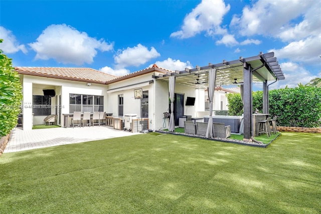 rear view of property featuring ceiling fan, a lawn, a pergola, and a patio area