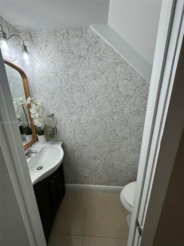 bathroom featuring toilet, vanity, and tile patterned flooring