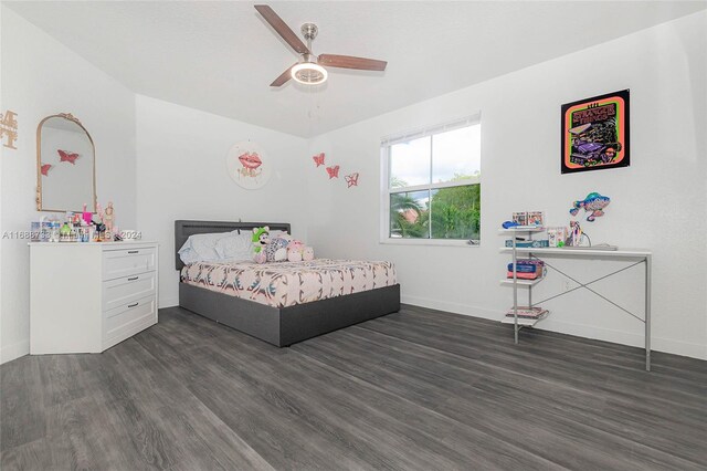 bedroom with dark hardwood / wood-style flooring and ceiling fan