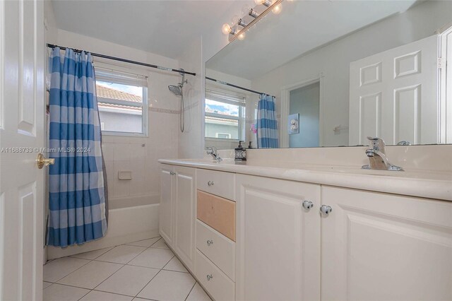 bathroom featuring vanity, shower / tub combo with curtain, and tile patterned flooring