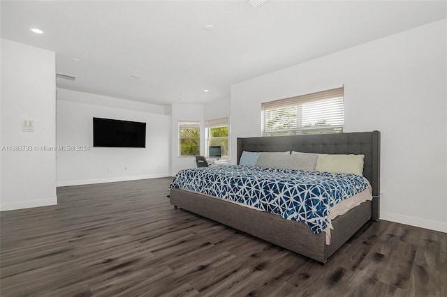 bedroom with dark hardwood / wood-style floors